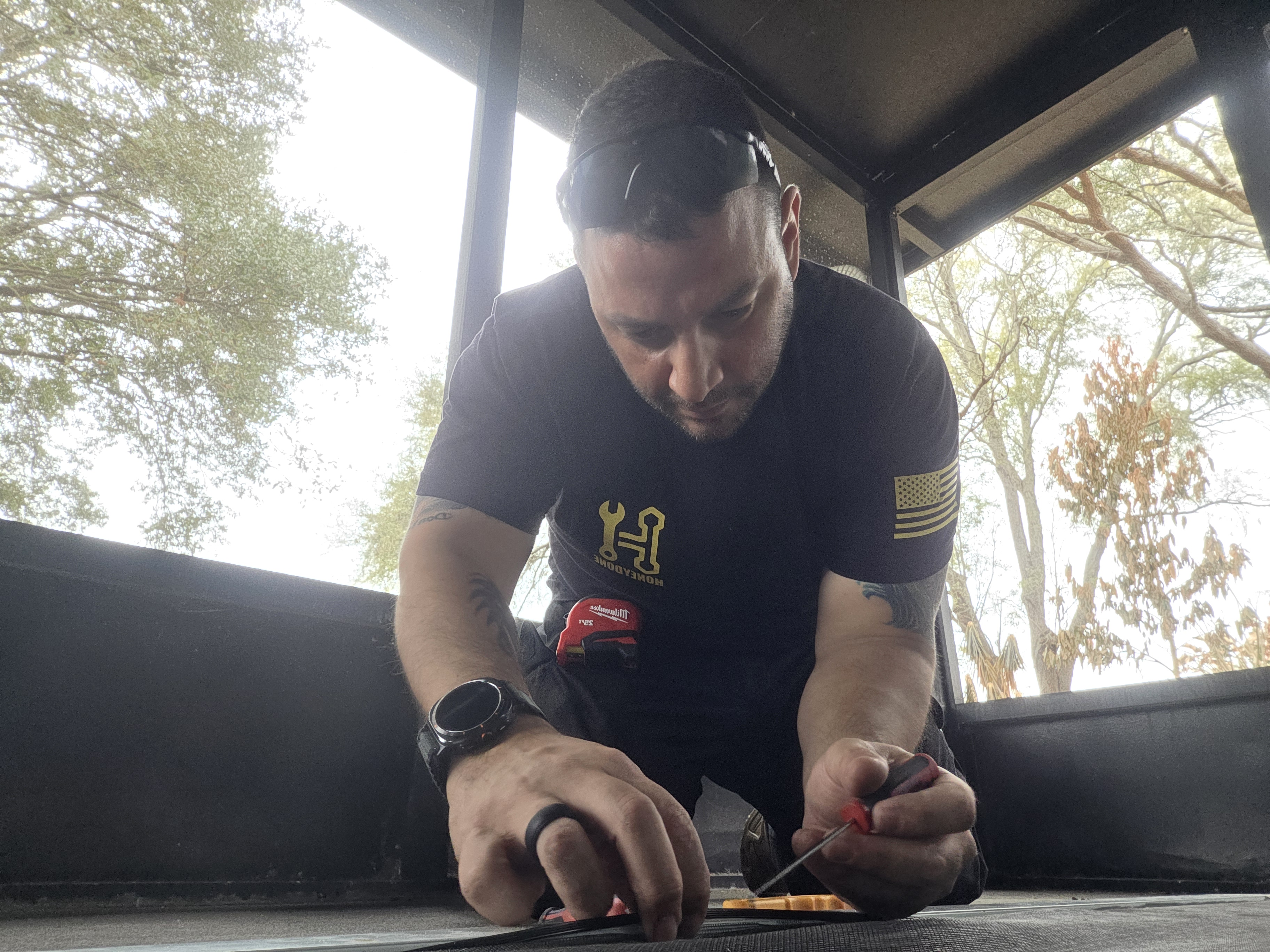 Manny Rivero, owner of HoneyDone, working on a repair job in Brevard County